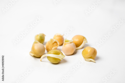 Sprouted pea bean seeds close up against a white background