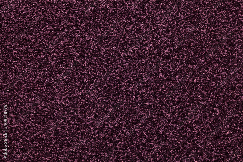 Grainy dark purple background with spotted pattern. Texture backdrop .