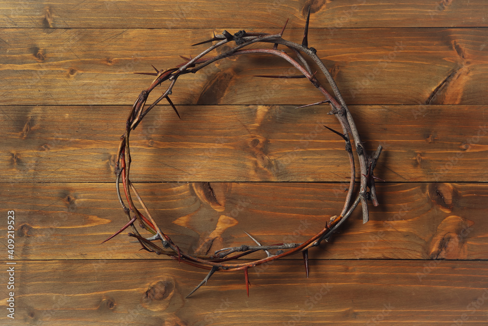 Crown of thorns on wooden table, top view. Easter attribute Crown of thorns on wooden table, top view. Easter attribute