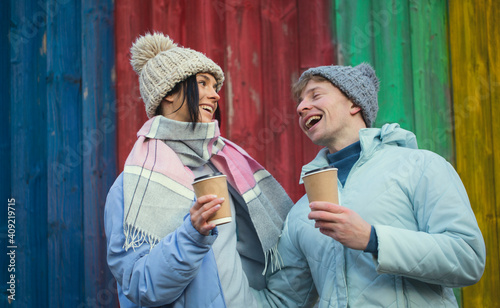 Happy young couple is drinking coffee and smiling. Love couple. Coffee. Fun. Wooden background. 