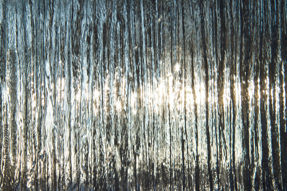Naklejka premium Ice covered glass with sun beams penetration.