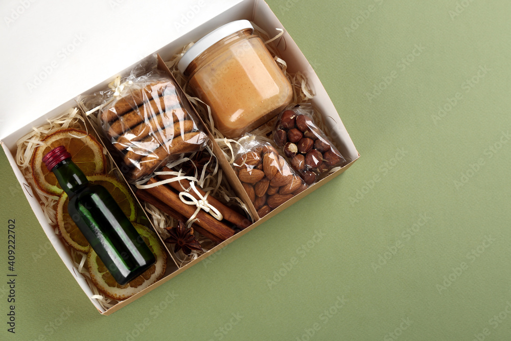 Stylish gift set on olive background, top view. Space for text Stylish gift set on olive background, top view. Space for text