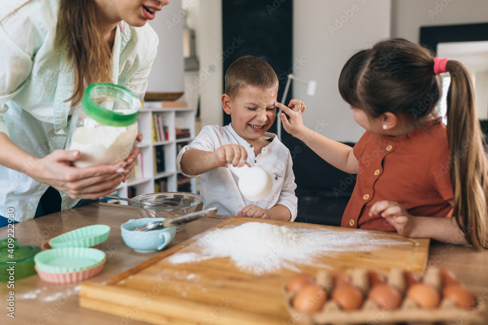 mother with her children baking at home