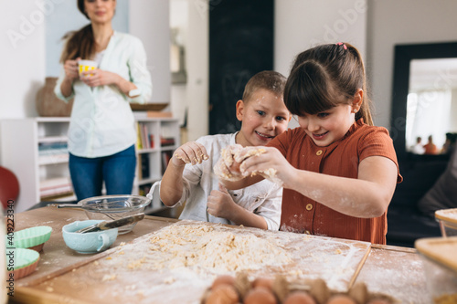 mother with her children baking at home