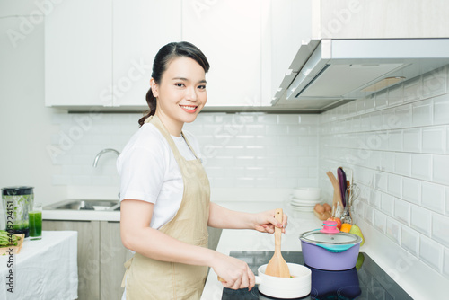 Beautiful woman cooking something in the kitchen