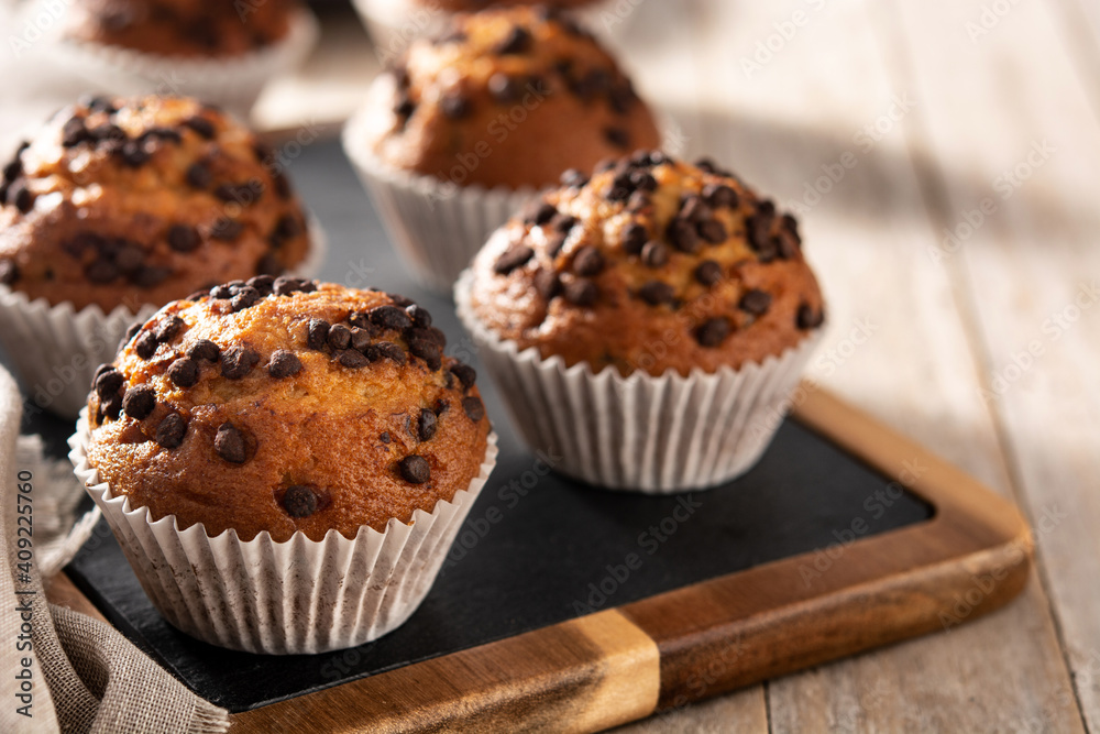 Just baked chocolate muffins on rustic wooden table Just baked chocolate muffins on rustic wooden table