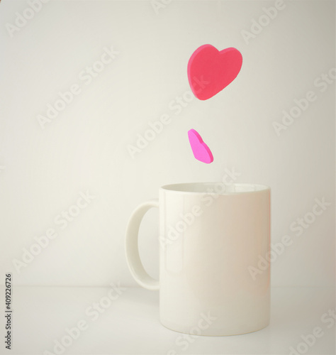 Valentine, hearts in the air, coming out of the cup. White background. Copy space.