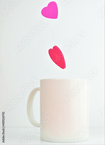 Valentine, hearts in the air, coming out of the cup. White background.