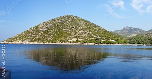 Reflection of picturesque hill in the sea