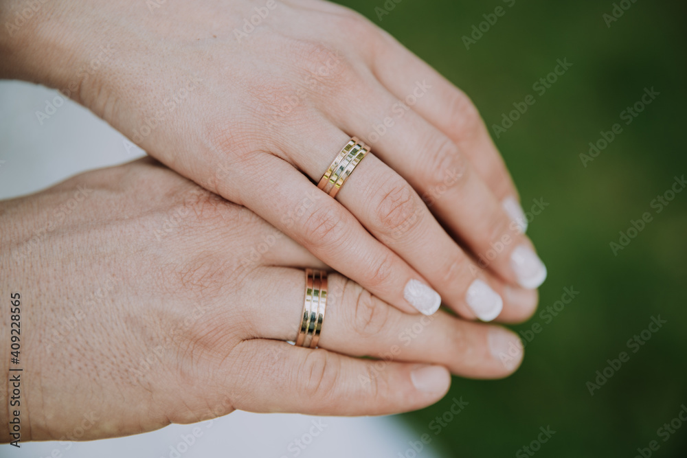 Holding hands with wedding rings. Bridal bouquet is held with bridal hands. Invitation to the wedding ceremony. Wedding rings. Flowers and shoes for the bride. Bridal shoes and jewellery Holding hands with wedding rings. Bridal bouquet is held with bridal hands. Invitation to the wedding ceremony. Wedding rings. Flowers and shoes for the bride. Bridal shoes and jewellery