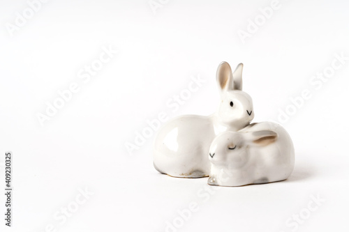 Ceramic white hares, vintage figurine on a white background