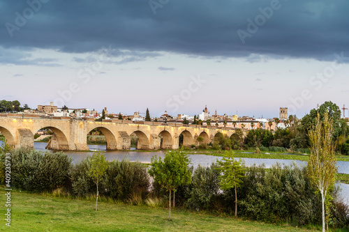 Medieval Palmas Bridge over wide river in Badajoz, Spain photo