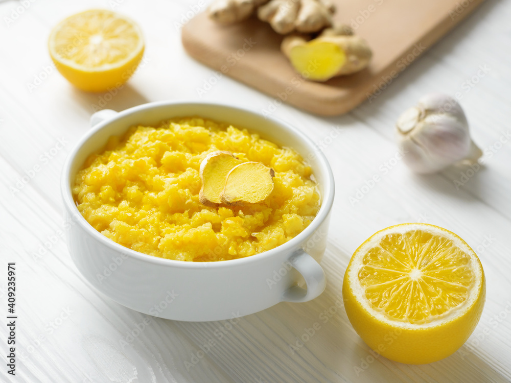 Natural home made remedy that will make immune system stronger and powerful with lemon and ginger with garlic on wooden background Natural home made remedy that will make immune system stronger and powerful with lemon and ginger with garlic on wooden background