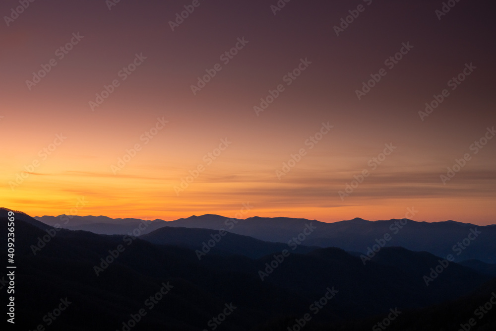 Purple Sky Lights Over Silhouetted Mountains