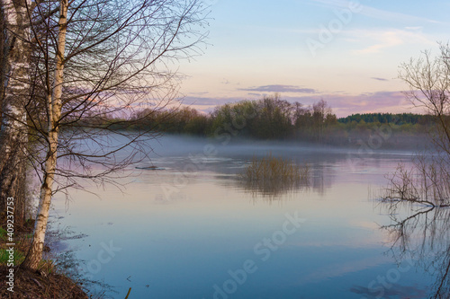 Spring nature. The river flooded, spring flood. Fog over the water. Horizontal photo.