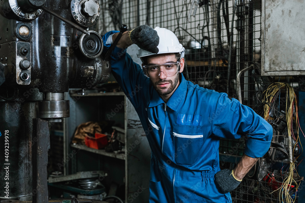 portrait man engineering wearing uniform safety and hardhat standing at machine in factory industrial, worker manufactory industry concept. portrait man engineering wearing uniform safety and hardhat standing at machine in factory industrial, worker manufactory industry concept.