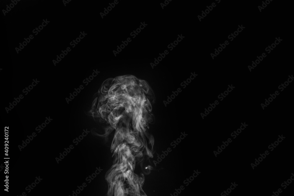 White vapour spray steam from air saturator. Smoke fragments on a black background. Abstract background, design element, for overlay on pictures
