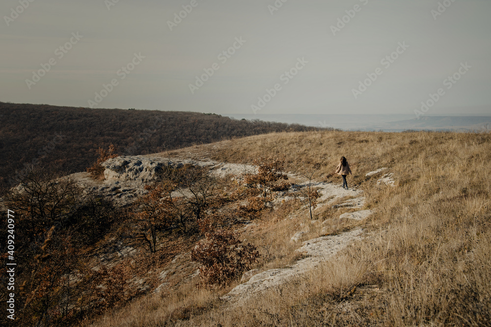 Autumn landscape in warm colors. The figure of a man walks along a path in the distance Autumn landscape in warm colors. The figure of a man walks along a path in the distance