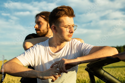 Young white european boys in the countryside with clouds behind