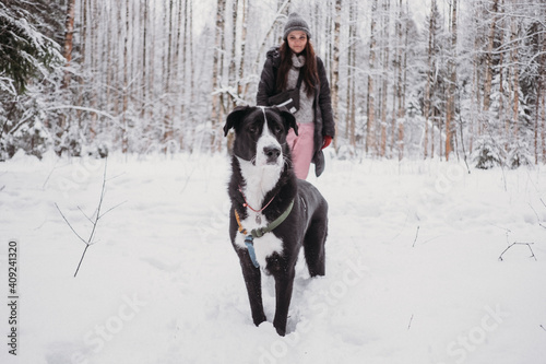 Young woman playing with her dog at winter forest. Lifestyle with dog © lamapacas