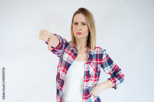 Young caucasian woman isolated on white background showing thumb down