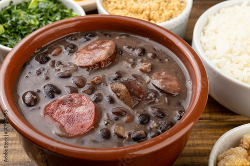 Traditional brazilian feijoada with rice, kale and manioc flour
