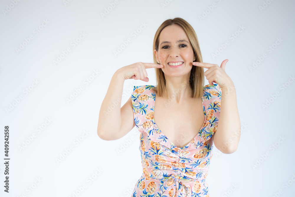 Picture of beautiful woman pointing to teeth over white background. Picture of beautiful woman pointing to teeth over white background.