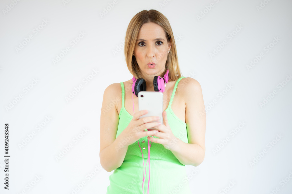 Portrait of a smiling young casual woman using mobile phone isolated over white background Portrait of a smiling young casual woman using mobile phone isolated over white background