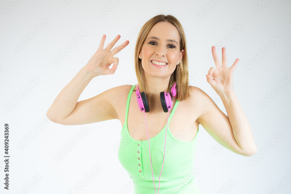 Happy young woman showing okay sign with fingers isolated over white background Happy young woman showing okay sign with fingers isolated over white background