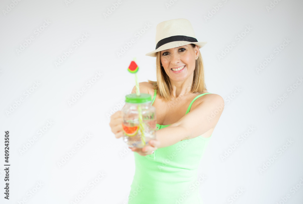 Portrait of gorgeous vacation woman wearing straw hat smiling and holding cold drink isolated over white background. Portrait of gorgeous vacation woman wearing straw hat smiling and holding cold drink isolated over white background.