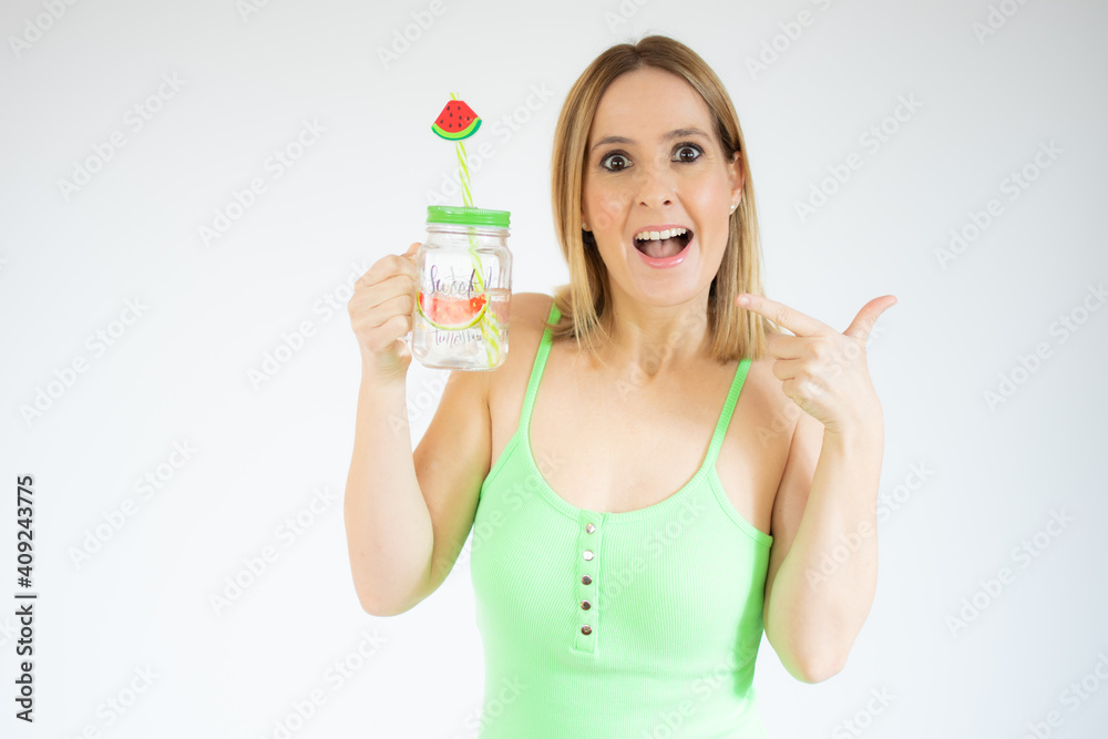 Portrait of gorgeous vacation woman smiling holding cold drink isolated over white background. Portrait of gorgeous vacation woman smiling holding cold drink isolated over white background.