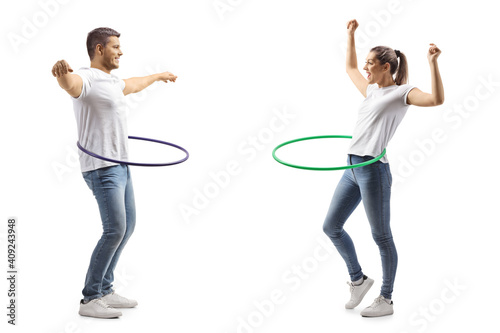 Young man and woman spinning a hula hoops photo