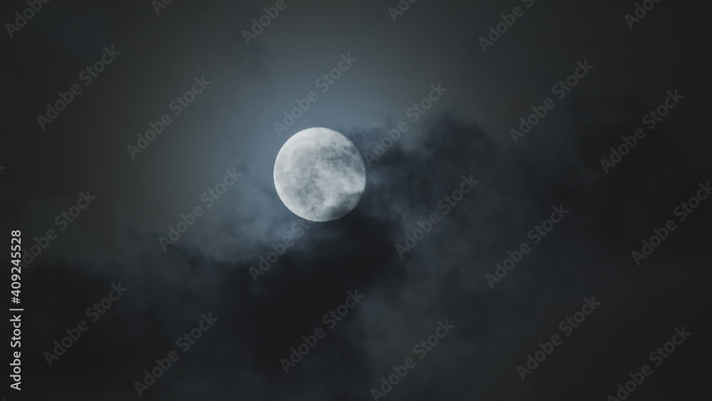 Full moon against cloudy night sky