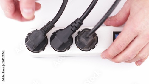 Filling Electric socket holes with electric plugs closeup footage