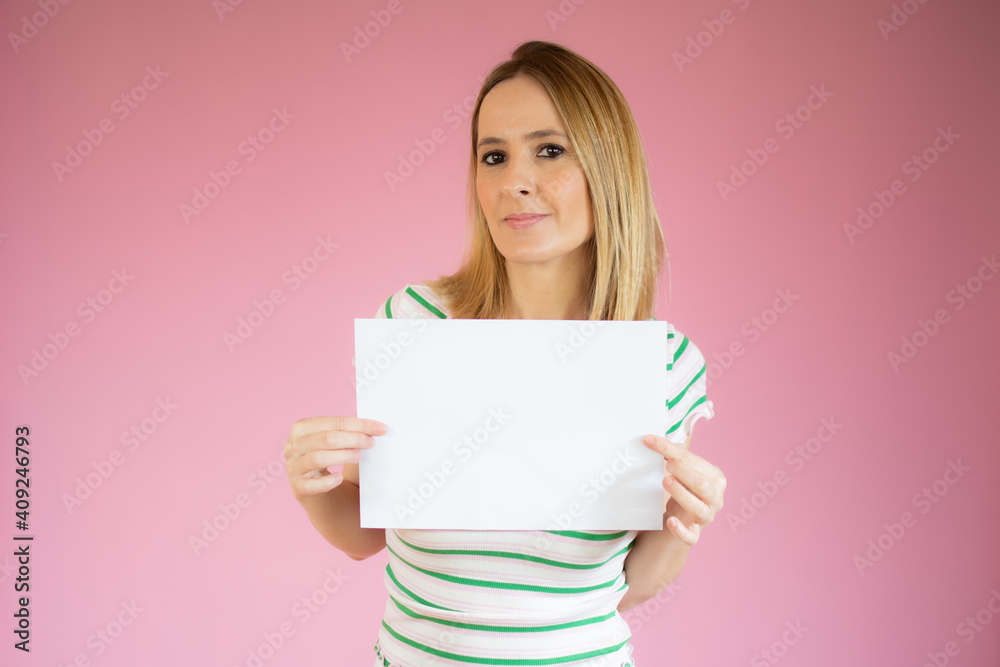 Young woman keeps with hand at the copy space, isolated over pink background. Young woman keeps with hand at the copy space, isolated over pink background.