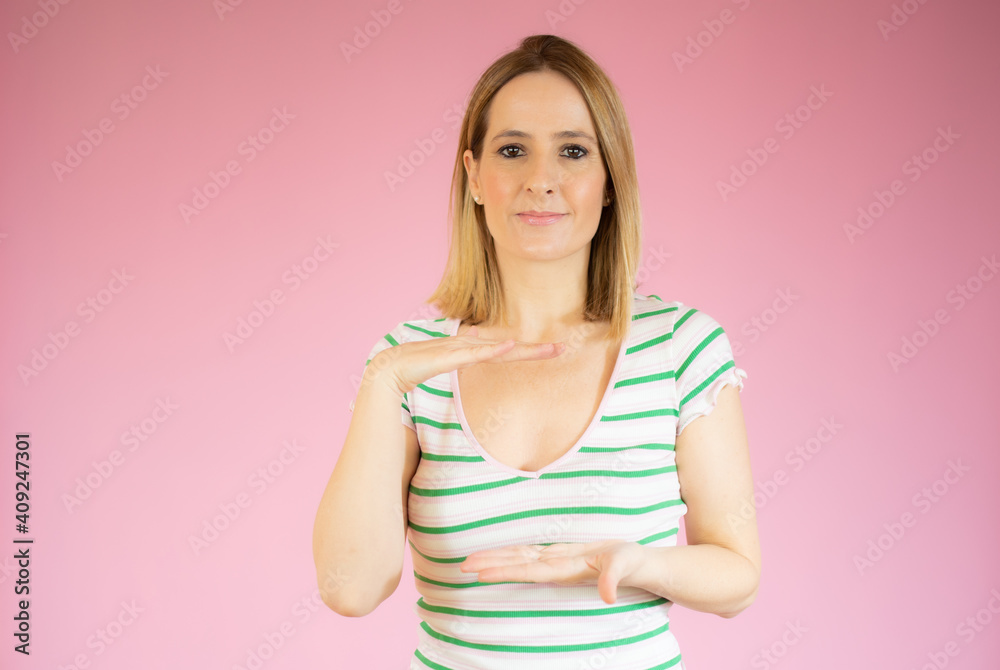 Young caucasian woman posing isolated holding something with both hands, product presentation. Young caucasian woman posing isolated holding something with both hands, product presentation.