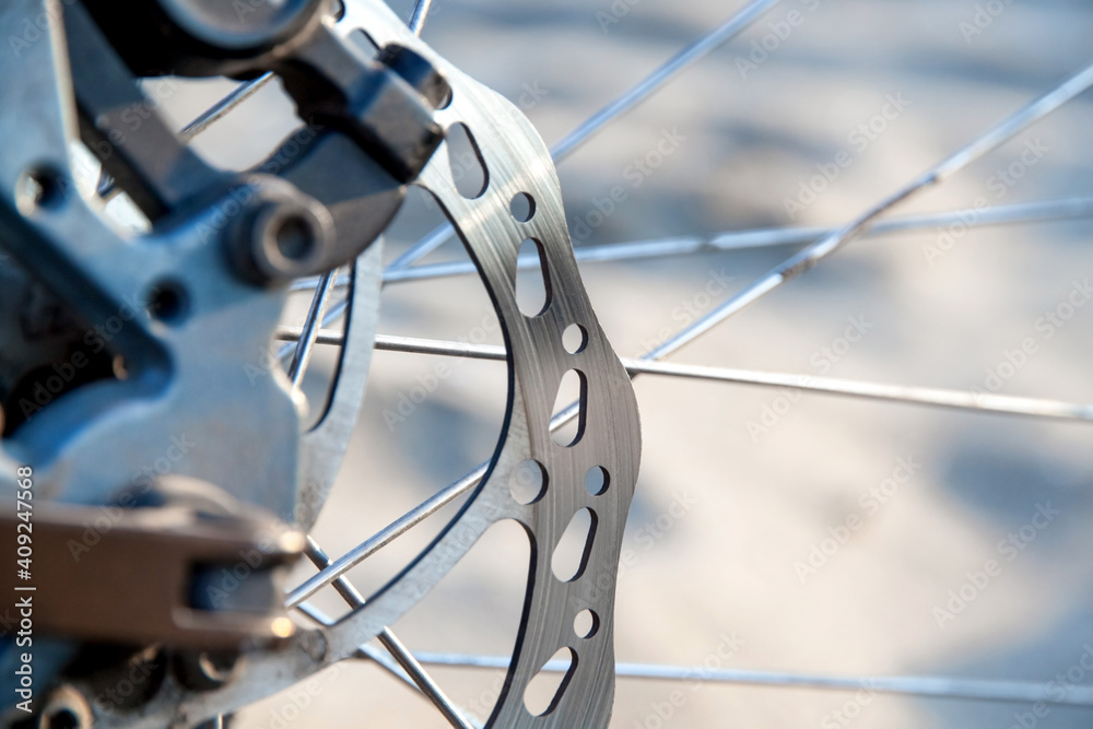 Used mountain bike disc brake close-up. Blurry background Used mountain bike disc brake close-up. Blurry background