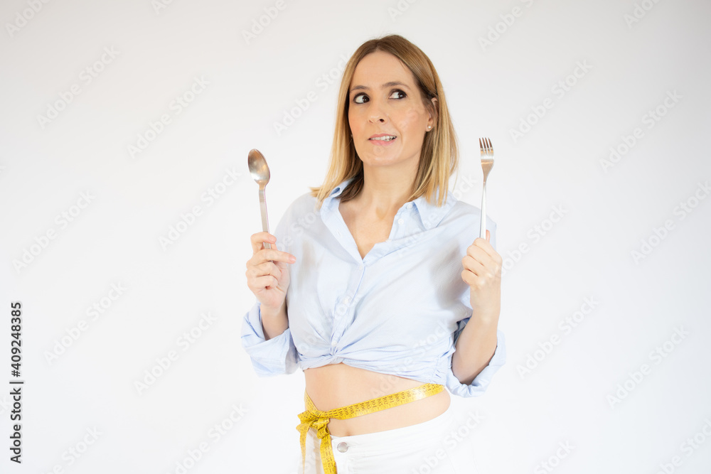 Young woman holding kitchen utensil against white background Young woman holding kitchen utensil against white background