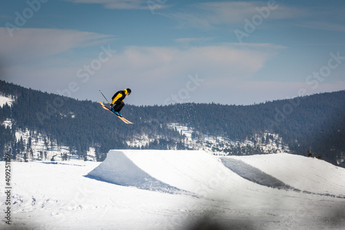 Skier skiing in the snowpark and jumping in air 
