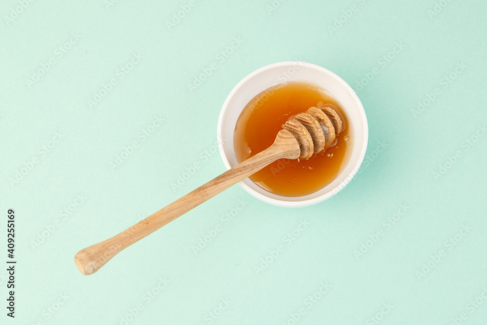 Honey with dipper in a plate Honey with dipper in a plate