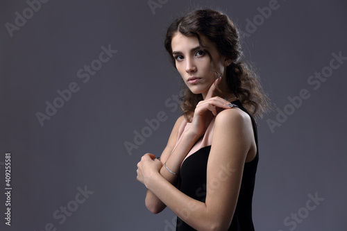 Studio portrait of a beautiful girl on a gray background