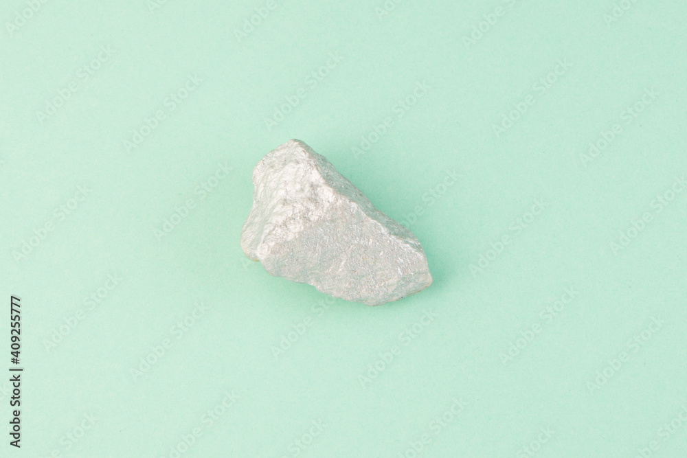 Rock on teal background top view Rock on teal background top view