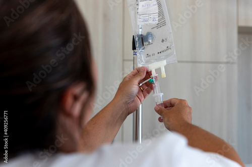 a caregiver checks an infusion