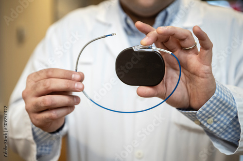 a doctor shows a pacemaker photo