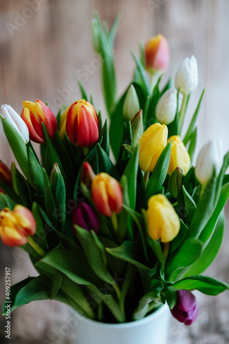 Colorful tulips with wooden background  spring flower still life
