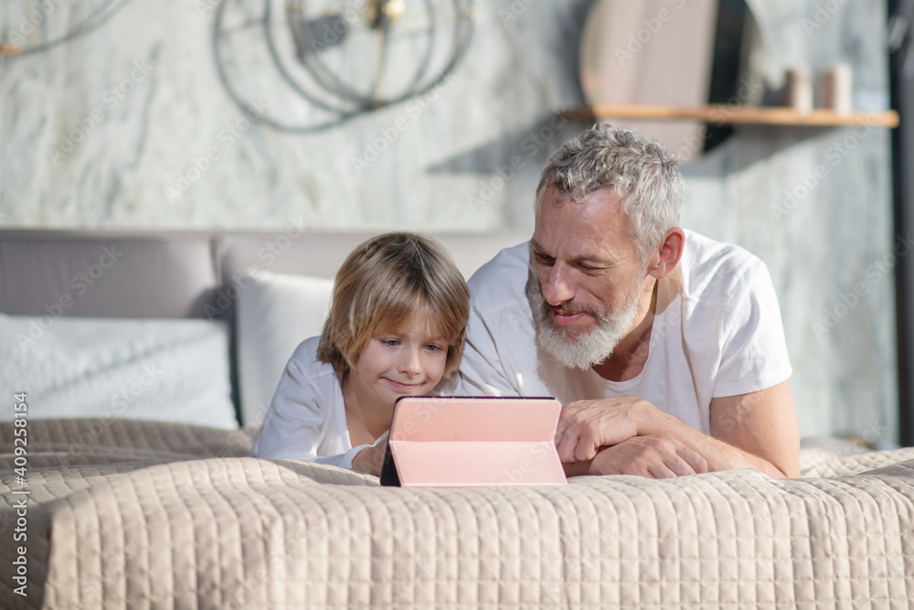 Happy smiling dad with baby with tablet Happy smiling dad with baby with tablet