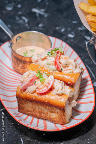 Lobster Roll.fresh Maine Lobster boiled, mixed with mayo, celery, chives served in toasted hero roll with crisp lettuce and drawn butter.