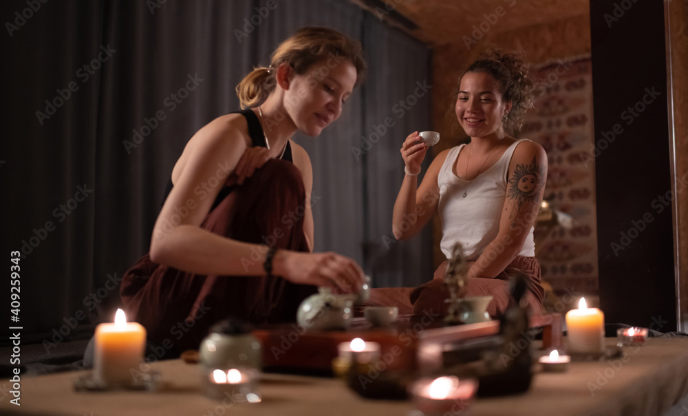 Glad woman watching instructor brewing Asian tea Glad woman watching instructor brewing Asian tea
