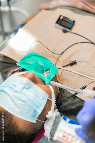 dentistry under general anesthesia. The dentist treats the patient under general anesthesia. dentist and assistant in the process.