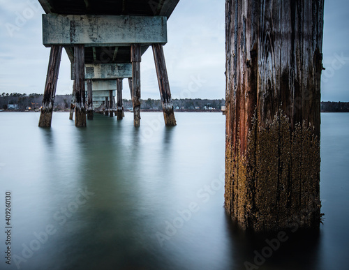 Long exposure of ocean water and pilings under bridge Yarmouth, Maine
